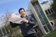 Dr Scott Watkins, CSIRO researcher, holds a sheet of flexible solar cells