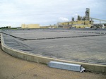 A Cooley Group floating cover in front of the Weyerhauser paper plant in Mississippi. There is growing interest in covering water reservoirs with solar fabric so that energy can be generated while evaporation is prevented. Photo: Cooley Group