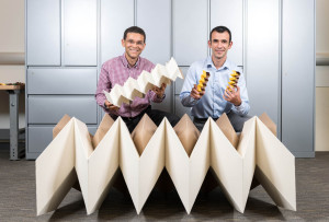 Researchers Glaucio Paulino (left) and Evgueni Filipov with three origami structures showing the size flexibility of the "zippered tube" system. Filipov is from University of Illinois at Urbana-Champaign; Paulino is from the Georgia Institute of Technology. Photo: Rob Felt, Georgia Tech.