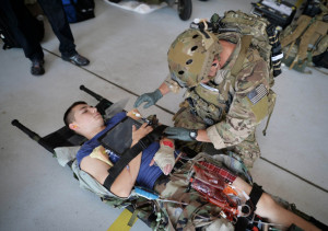 A New York Air National Guard pararescue jumper works on a simulated patient during a casualty drill conducted to help evaluate technology designed to help them monitor patients in the field. The technology is being developed as part of the Air Force BATMAN program to put wearable computer systems into the hands of warfighters. Photo: U.S. Air National Guard photo by Staff Sergeant Christopher S Muncy/Released. 