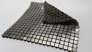 This metallic "space fabric" was created using 3-D printed techniques that add different functionality to each side of the material. Photo: NASA/JPL-Caltech. 
